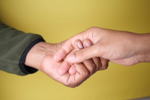 Two hands joined together firmly, beautifully representing unity, support, and a strong bond