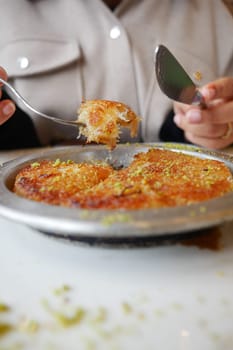 kunafa with a wipe cream on a plate