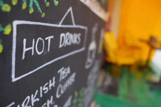 The chalkboard menu showcases a wonderful selection of hot drinks, including Turkish tea and coffee