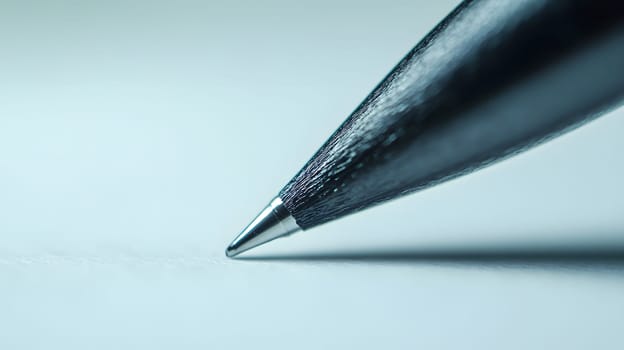 Close-up of a pen tip poised above a blank page.