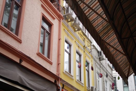 The vibrant architecture showcases charming pastelcolored buildings nestled within a quaint alley