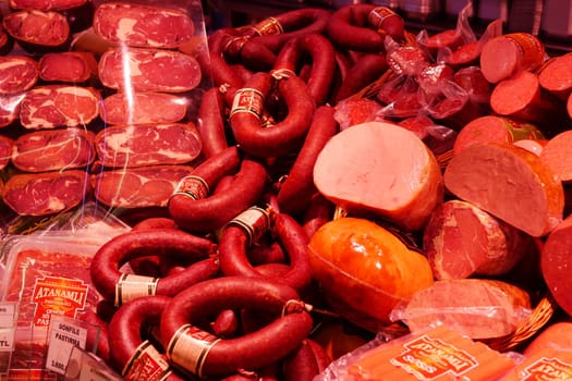 An enticing and colorful assortment of assorted sausages and cold cuts displayed in a market