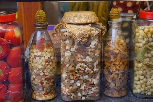 Canned fruits and vegetables in glass jars.