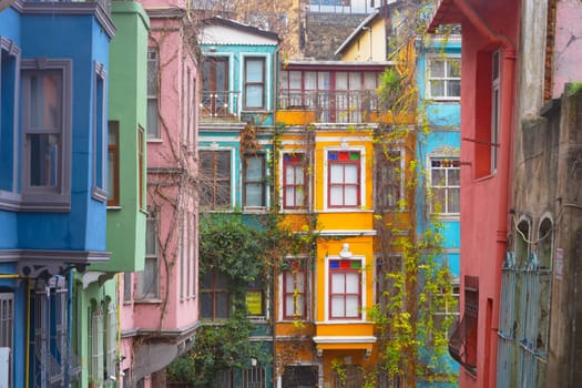A charming alley that is beautifully lined with brightly painted historic buildings all around