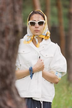 Fashion outdoor photo of beautiful young woman looking like elegant lady,wearing white jacket and accessories. Scarf trendy fashion accessory season