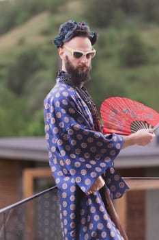 Young man wearing bathrobe night suit posing outdoor.