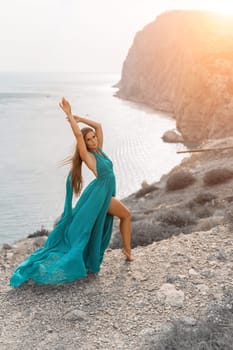 Woman sea trevel green dress. Side view a happy woman with long hair in a long mint dress posing on a beach with calm sea bokeh lights on sunny day. Girl on the nature on blue sky background