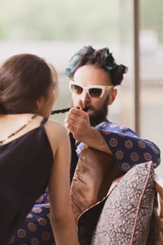 Close-up of young romantic couple is kissing and enjoying the company of each other at home