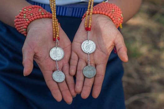 Preserving History: Indigenous Woman Displaying Ecuador's Antique Sucre Coins. High quality photo