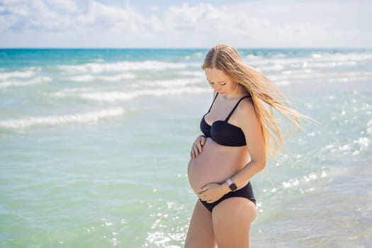 Radiant pregnant woman in a swimsuit, amid the stunning backdrop of a turquoise sea. Serene beauty of maternity by the shore.