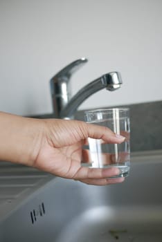 water pouring from a faucet tap slow motion .