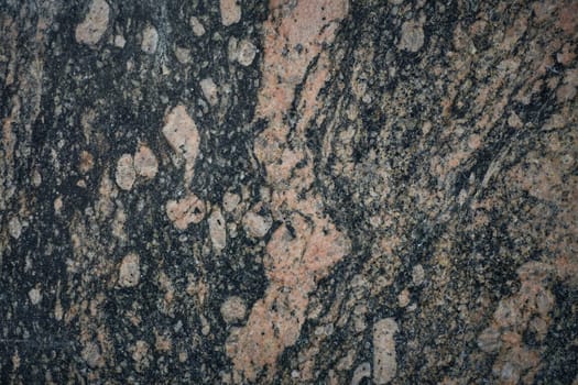 A close-up of a granite stone highlighting its rich mineral diversity and sparkling crystals