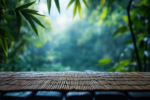 Tropical green background with empty bamboo table top in front. Exotic summer panoramic banner with copy space.