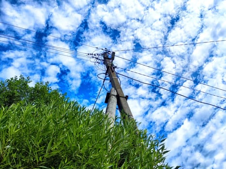 Old pole with wires against the sky. Electric transmission line, Eco-friendly energy