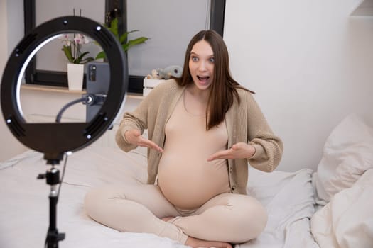A joyful and radiant pregnant woman proudly showcasing her baby bump in a beautifully cozy bedroom setting