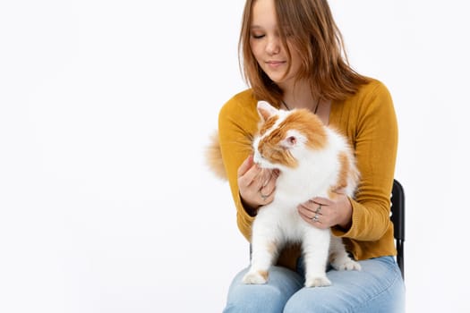 A joyful woman holds her fluffy cat, capturing the bond of pet companionship that brings comfort and happiness