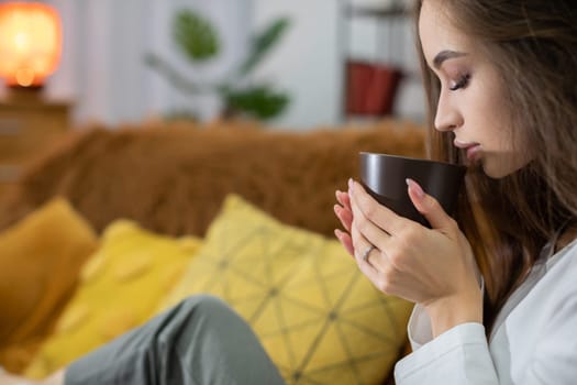 In this serene moment of genuine relaxation, I am enjoying a warm drink while nestled in a cozy living space