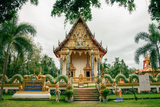 A stunning temple with intricate designs is set among vibrant foliage and serene natural surroundings