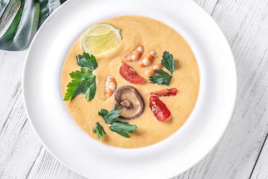 Authentic Thai Tom Yum soup with coconut milk, shrimp, and fresh herbs