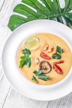 Authentic Thai Tom Yum soup with coconut milk, shrimp, and fresh herbs