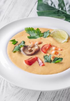 Authentic Thai Tom Yum soup with coconut milk, shrimp, and fresh herbs