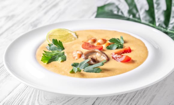 Authentic Thai Tom Yum soup with coconut milk, shrimp, and fresh herbs
