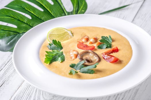 Authentic Thai Tom Yum soup with coconut milk, shrimp, and fresh herbs