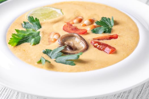 Authentic Thai Tom Yum soup with coconut milk, shrimp, and fresh herbs