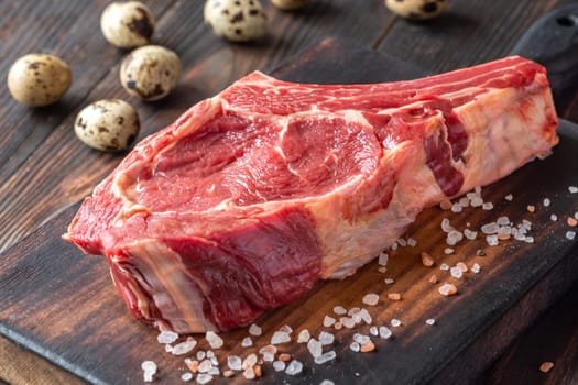 Fresh, high-quality cowboy steak with perfect marbling, ideal for grilling or pan-searing