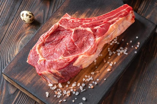 Fresh, high-quality cowboy steak with perfect marbling, ideal for grilling or pan-searing