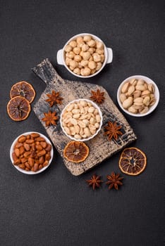 Delicious nutritious peanut in ceramic bowl on dark concrete background