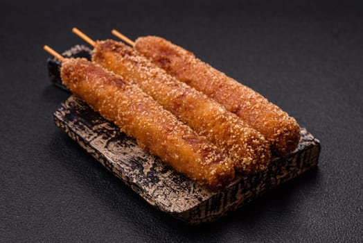 Lula kebab meat fried on a fire in breading with salt, spices and herbs on a dark concrete background