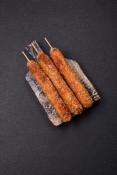 Lula kebab meat fried on a fire in breading with salt, spices and herbs on a dark concrete background