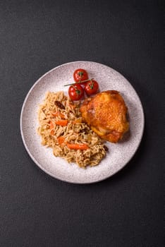 Delicious fresh pilaf with rice, carrots, meat, onions, spices and berries on a ceramic plate on a dark concrete background