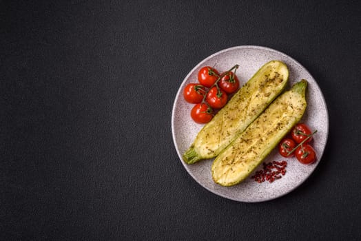 Delicious zucchini cut into two halves baked with salt, spices and herbs on a dark concrete background