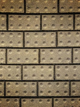 Background from a brick wall of mustard color and with dark seams. High quality photo