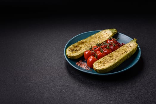 Delicious zucchini cut into two halves baked with salt, spices and herbs on a dark concrete background