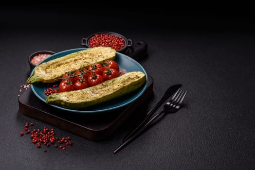 Delicious zucchini cut into two halves baked with salt, spices and herbs on a dark concrete background