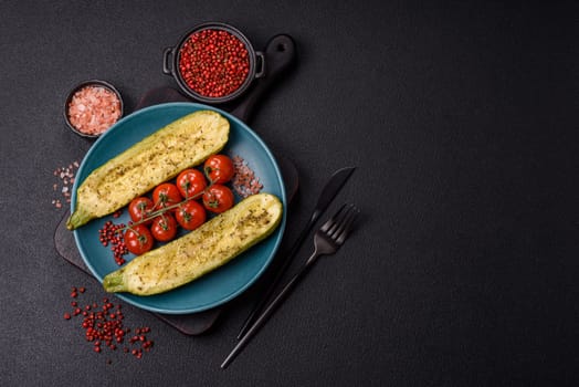 Delicious zucchini cut into two halves baked with salt, spices and herbs on a dark concrete background