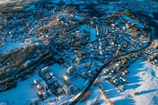 Panoramic aerial view of Zlatibor town and low cloud over Zlatibor Mountain at winter sunset, Cajetina, Serbia.