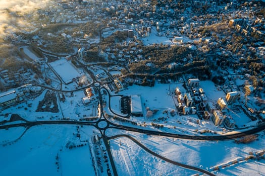 Panoramic aerial view of Zlatibor town and low cloud over Zlatibor Mountain at winter sunset, Cajetina, Serbia.