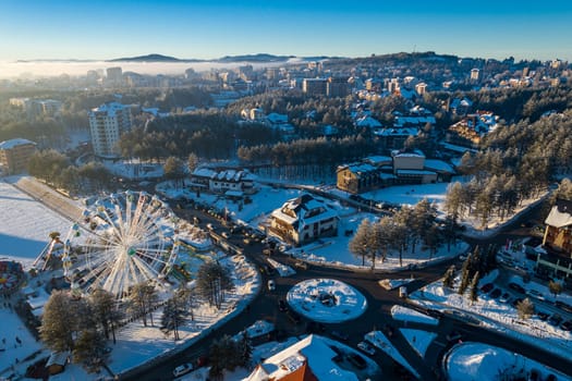 Panoramic aerial view of Zlatibor amusement park and low cloud over Zlatibor Mountain at winter sunset, Cajetina, Serbia.
