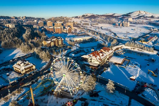 Panoramic aerial view of Zlatibor amusement park and low cloud over Zlatibor Mountain at winter sunset, Cajetina, Serbia.