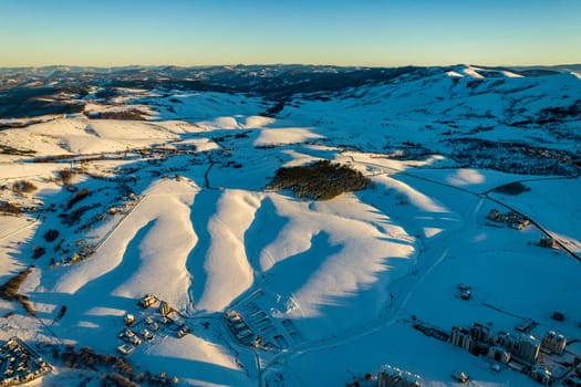 Panoramic aerial view of Zlatibor town and clear sky over Zlatibor Mountain at winter sunset, Cajetina, Serbia.