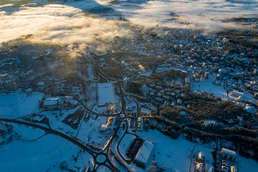 Panoramic aerial view of Zlatibor town and low cloud over Zlatibor Mountain at winter sunset, Cajetina, Serbia.