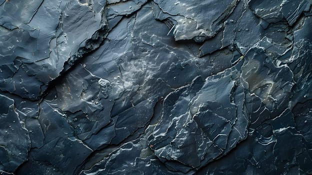 A close up of a grey bedrock rock with a marble texture resembling an intrusion of electric blue pattern, giving the appearance of freezing water