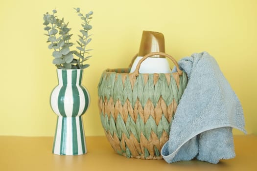 Eco-Friendly Woven Basket with Household Items and Cloth on Vibrant Background.