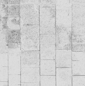 An abstract painted image of a wall lined with white old blocks in close-up