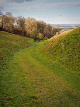 Walking down Kingstone Coombes, a dry valley formed during the Ice Age, from the Ridgeway, with the village of Ashbury visible in the distance, Oxfordshire, UK