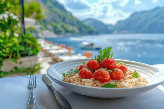 A plate of creamy strawberry risotto garnished with fresh herbs, set against a coastal backdrop with blue waters and lush hills